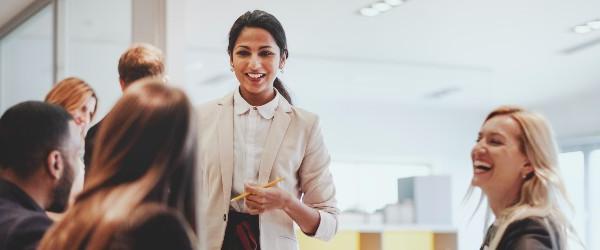 a person smiling with people around the