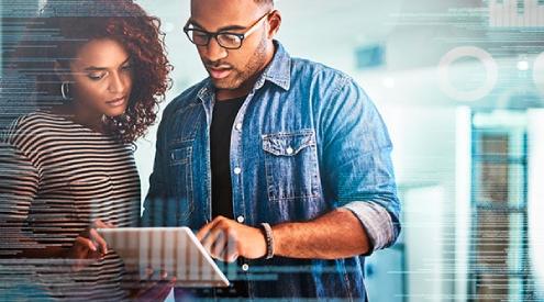 A man and woman looking at a laptop