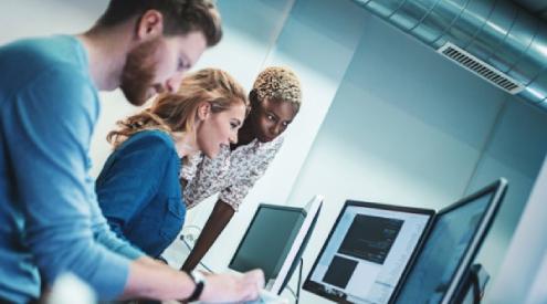 a group of people looking at a computer screen