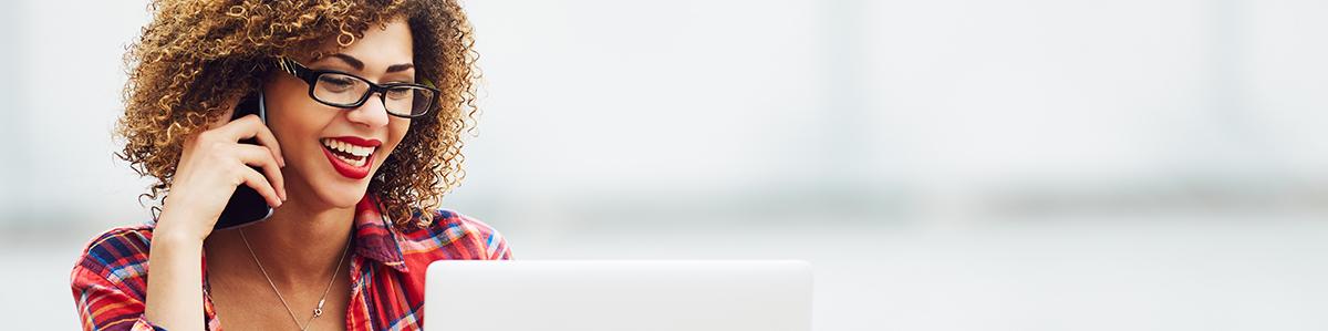 a woman sitting in front of a laptop